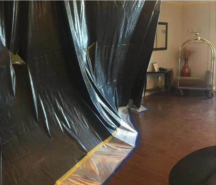 Image of a hotel room with containments to avoid further water damage 