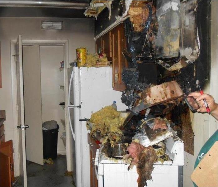 Kitchen covered in soot, smoke and water damage after a grease fire