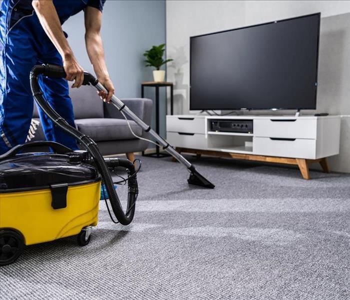 Image of a person person cleaning a carpet